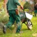 A man pulling a wheelbarrow with a wheel