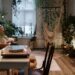 A cozy living room with plants, a hammock, and a vintage turntable, perfect for relaxation.