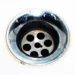 Detailed image of a chrome sink drain showcasing water droplets and a metallic finish.